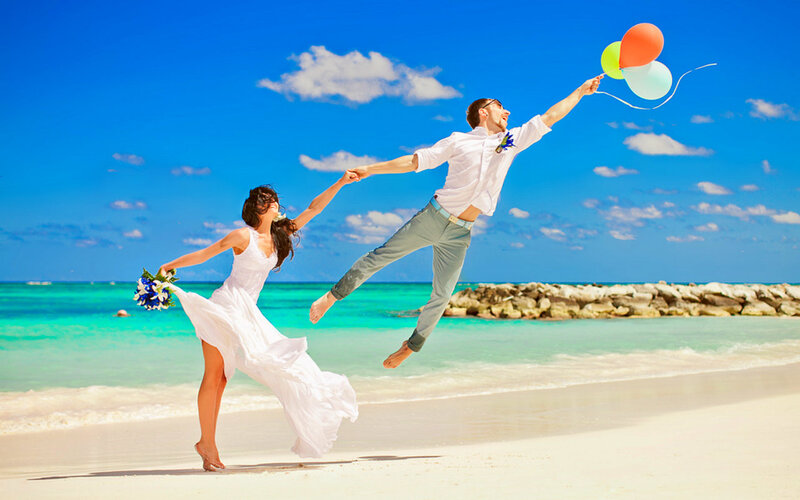 Couple Jumping on Beach