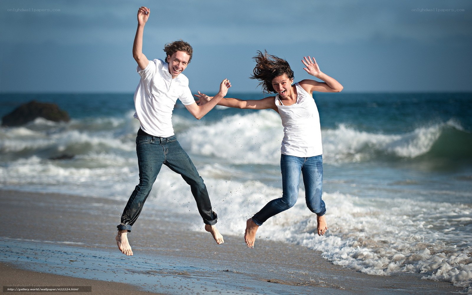 Couple jumping on the beach
