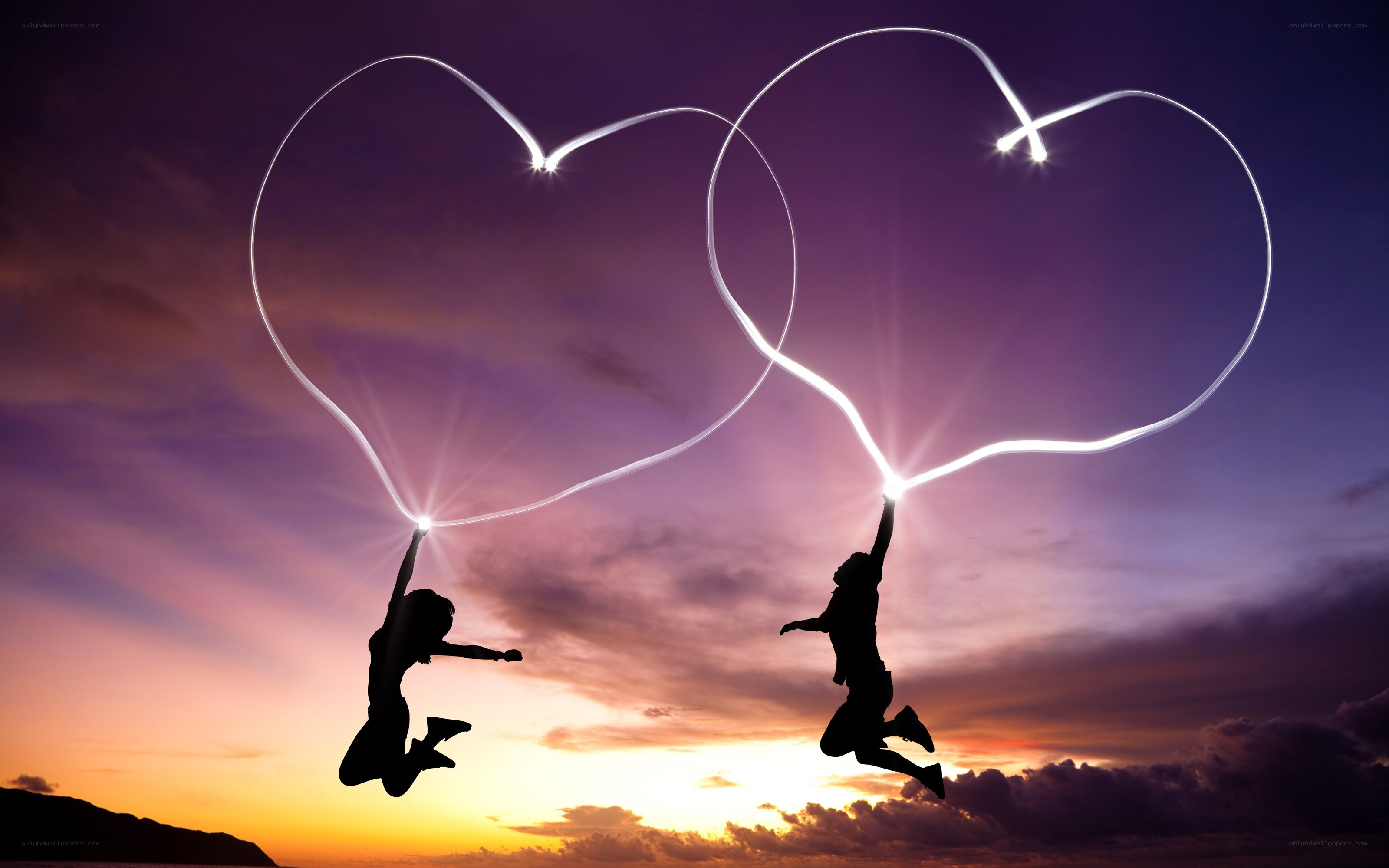 Couple jumping with light hearts