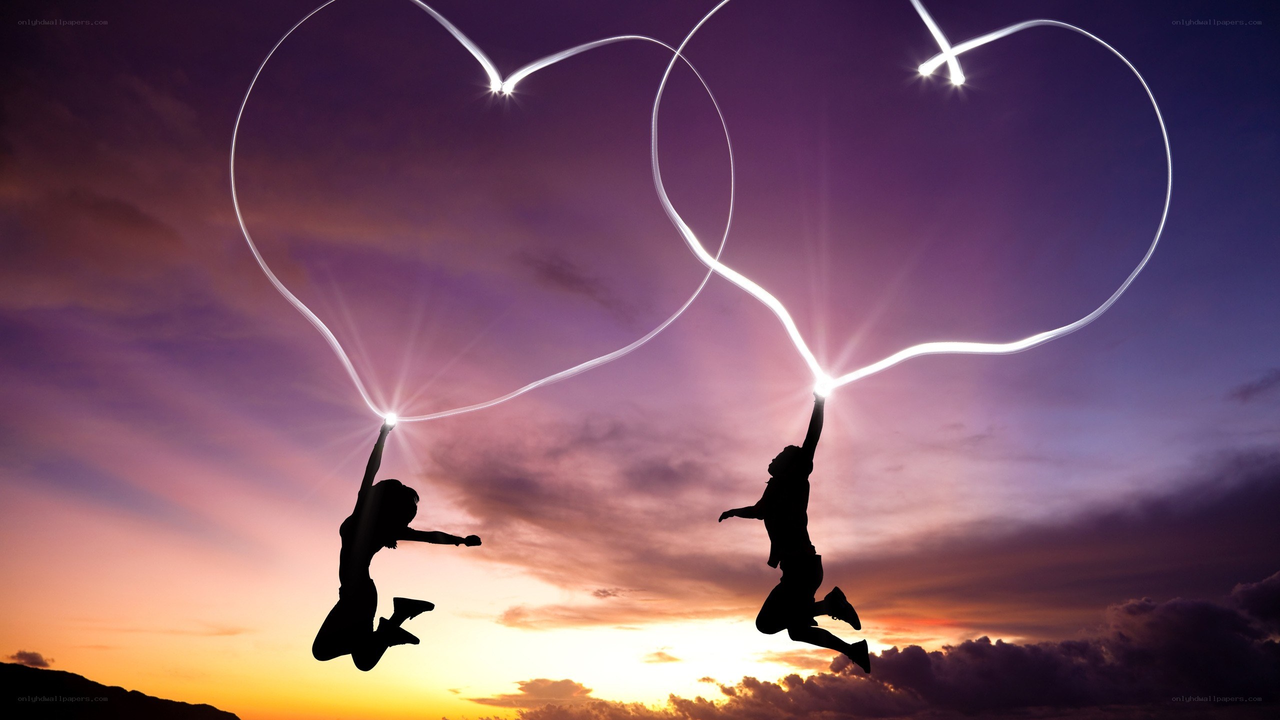 Couple jumping with light hearts