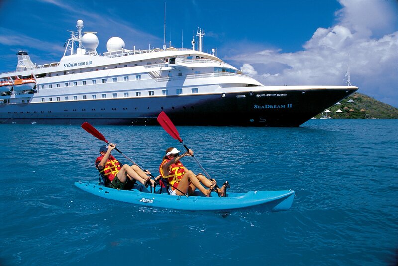 Couple kayaking near cruise ship