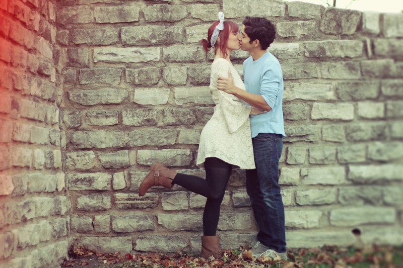Couple Kissing Against Wall