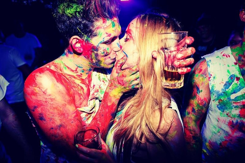 Couple kissing at color festival