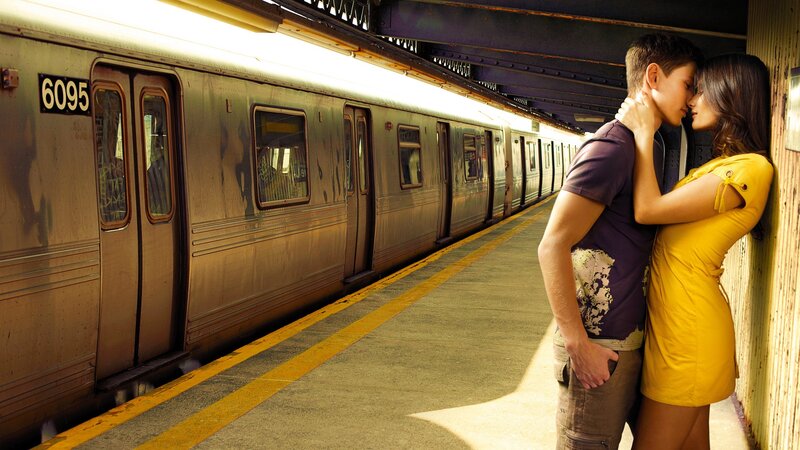Couple kissing at subway station