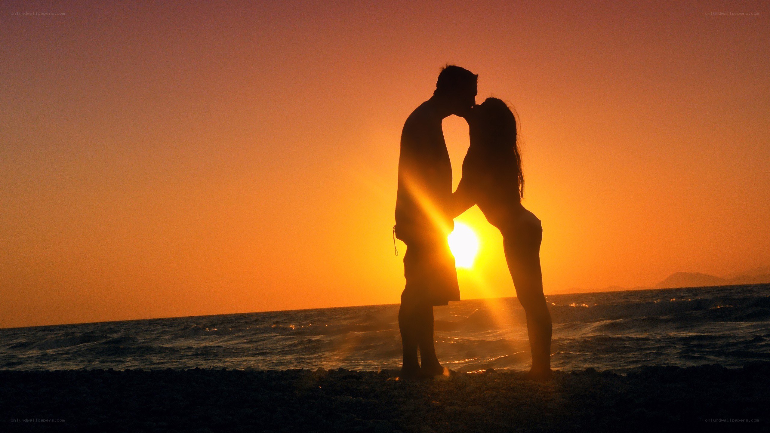 Couple kissing at sunset
