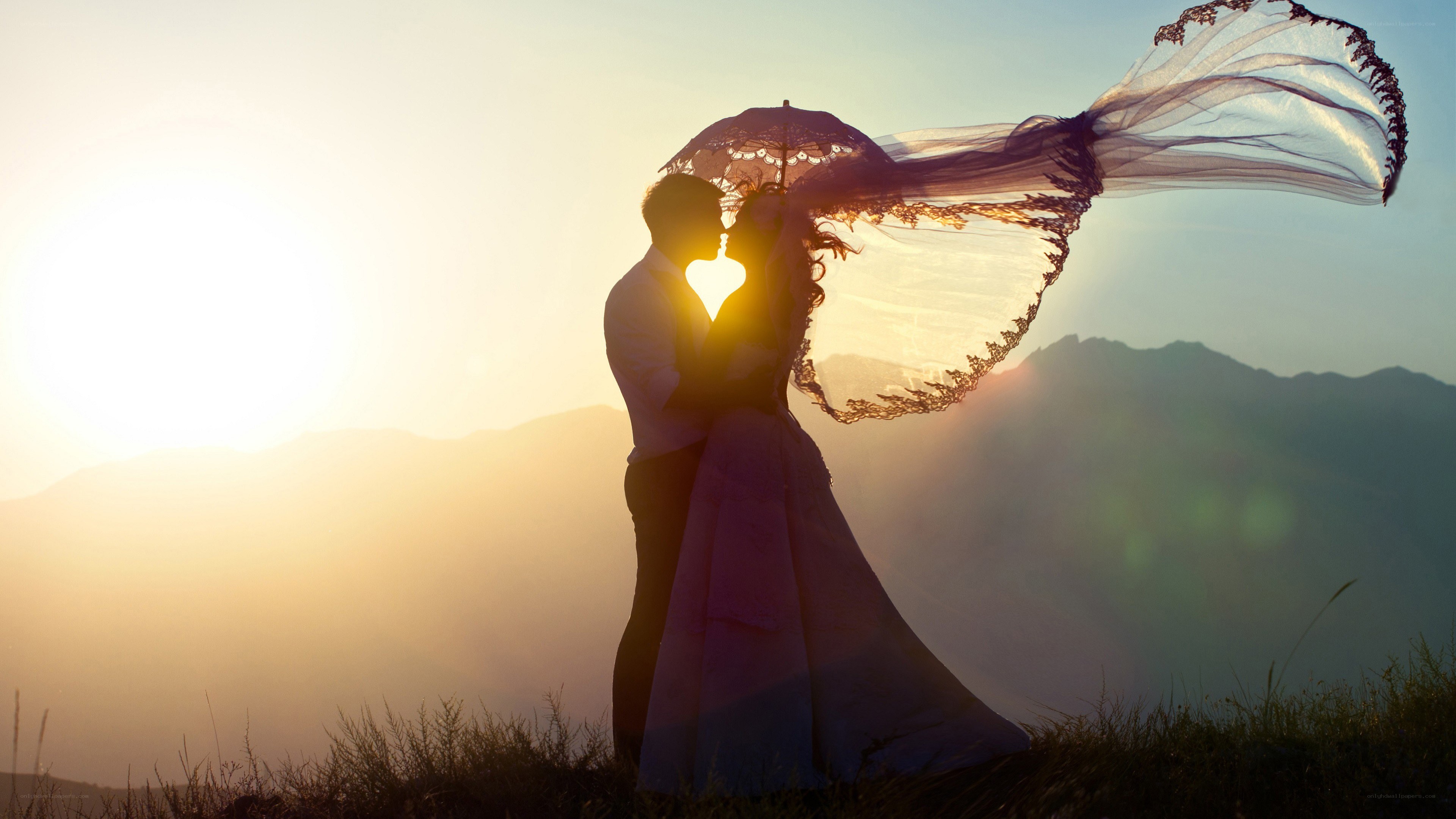 Couple kissing at sunset