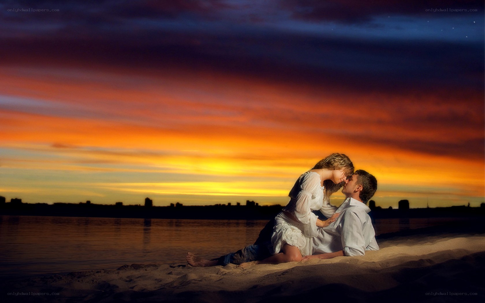 Couple kissing at sunset
