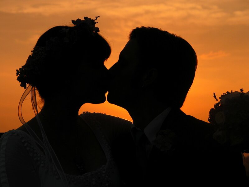 couple kissing at sunset