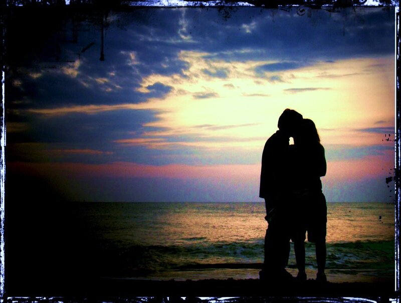 Couple kissing at sunset