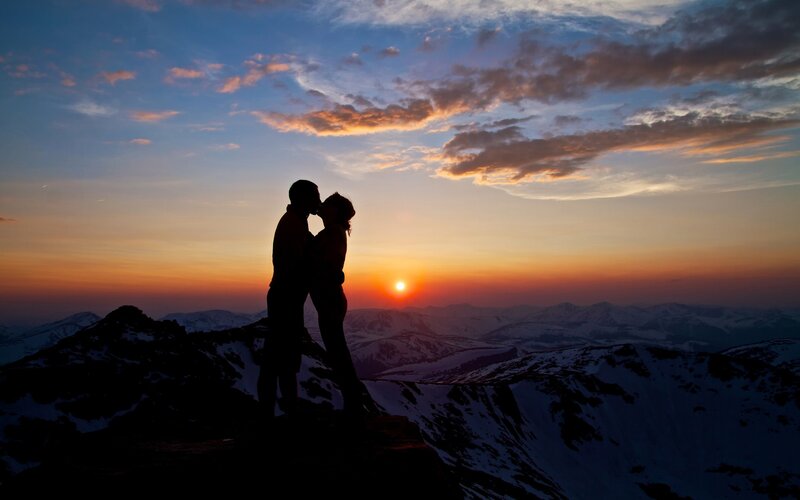 Couple kissing at sunset on mountain