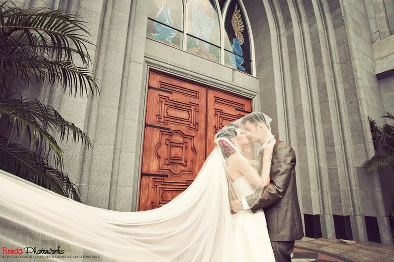 Couple kissing by church doors