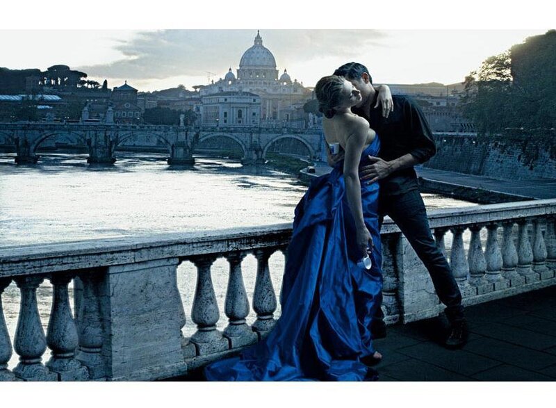 Couple kissing by river in Rome