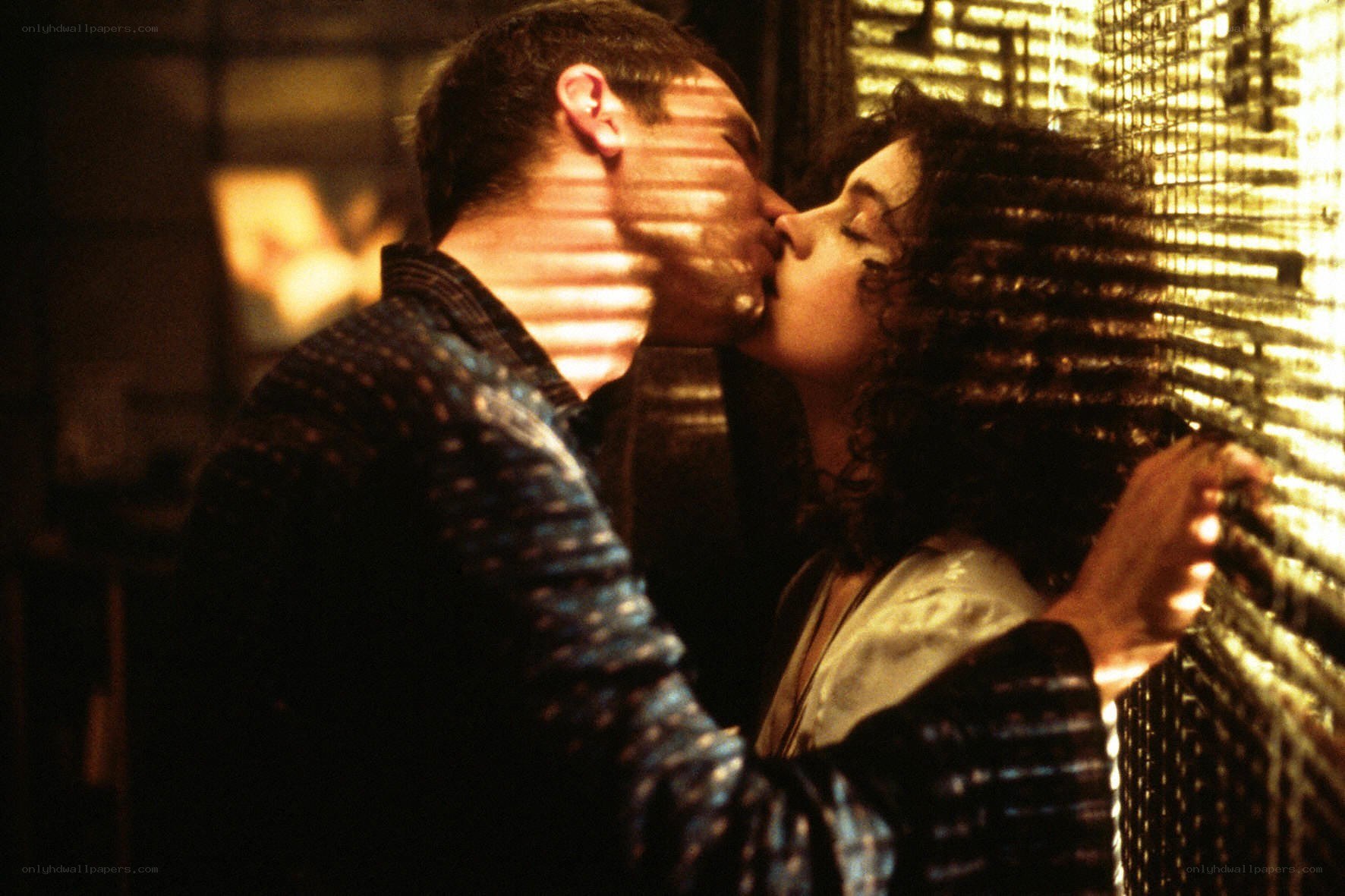 couple kissing by window