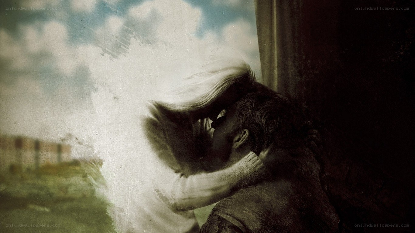 couple kissing by window