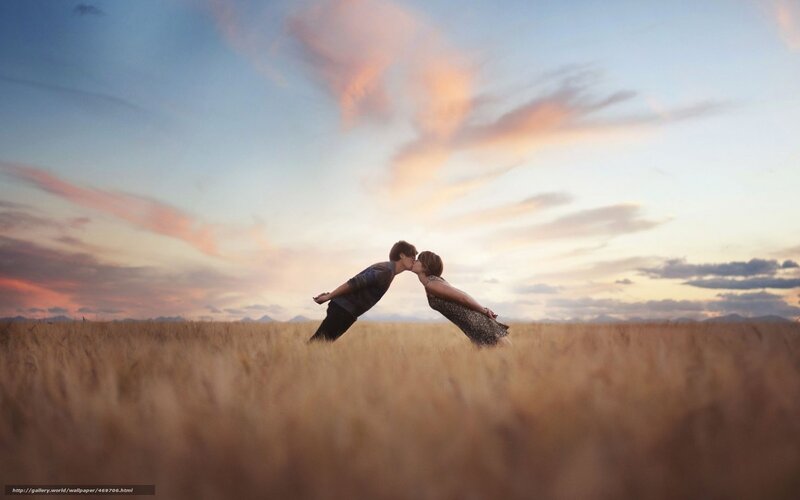 Couple kissing in a field