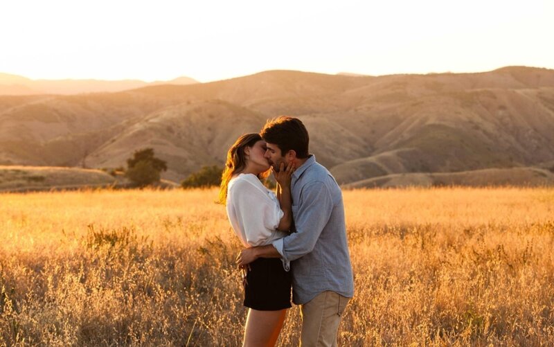 Couple kissing in a field