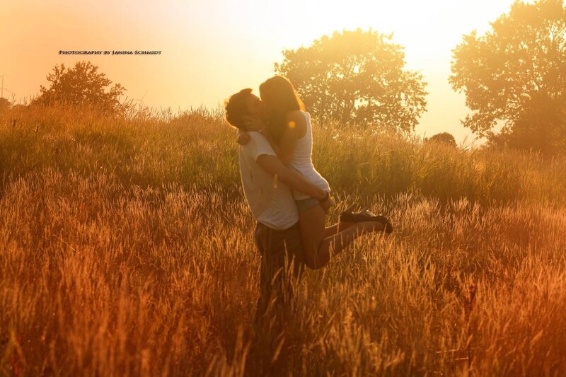 Couple kissing in a field
