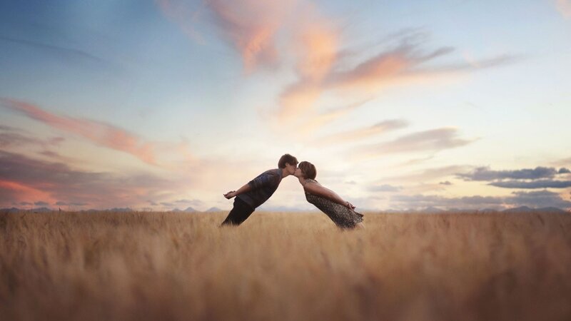 couple kissing in a field