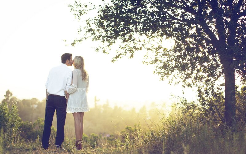 Couple kissing in a field