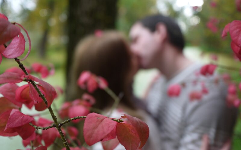 couple kissing in autumn park