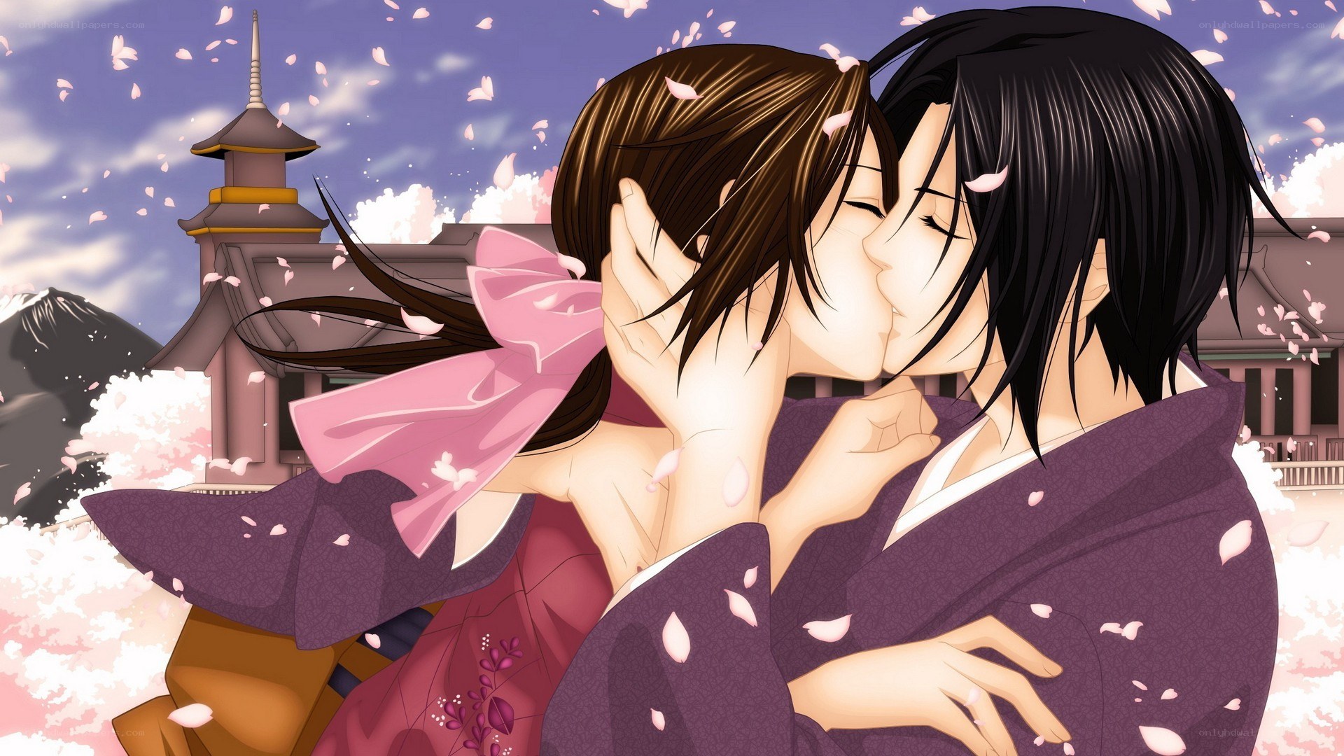 couple kissing in cherry blossoms