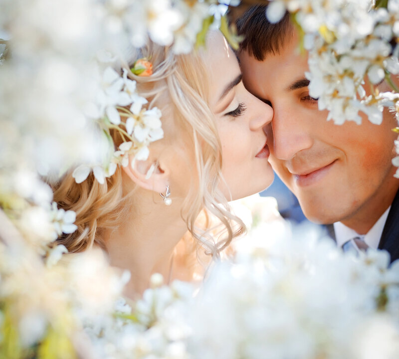 Couple Kissing in Flowers — White, Romantic, Spring, Photograph, Bride