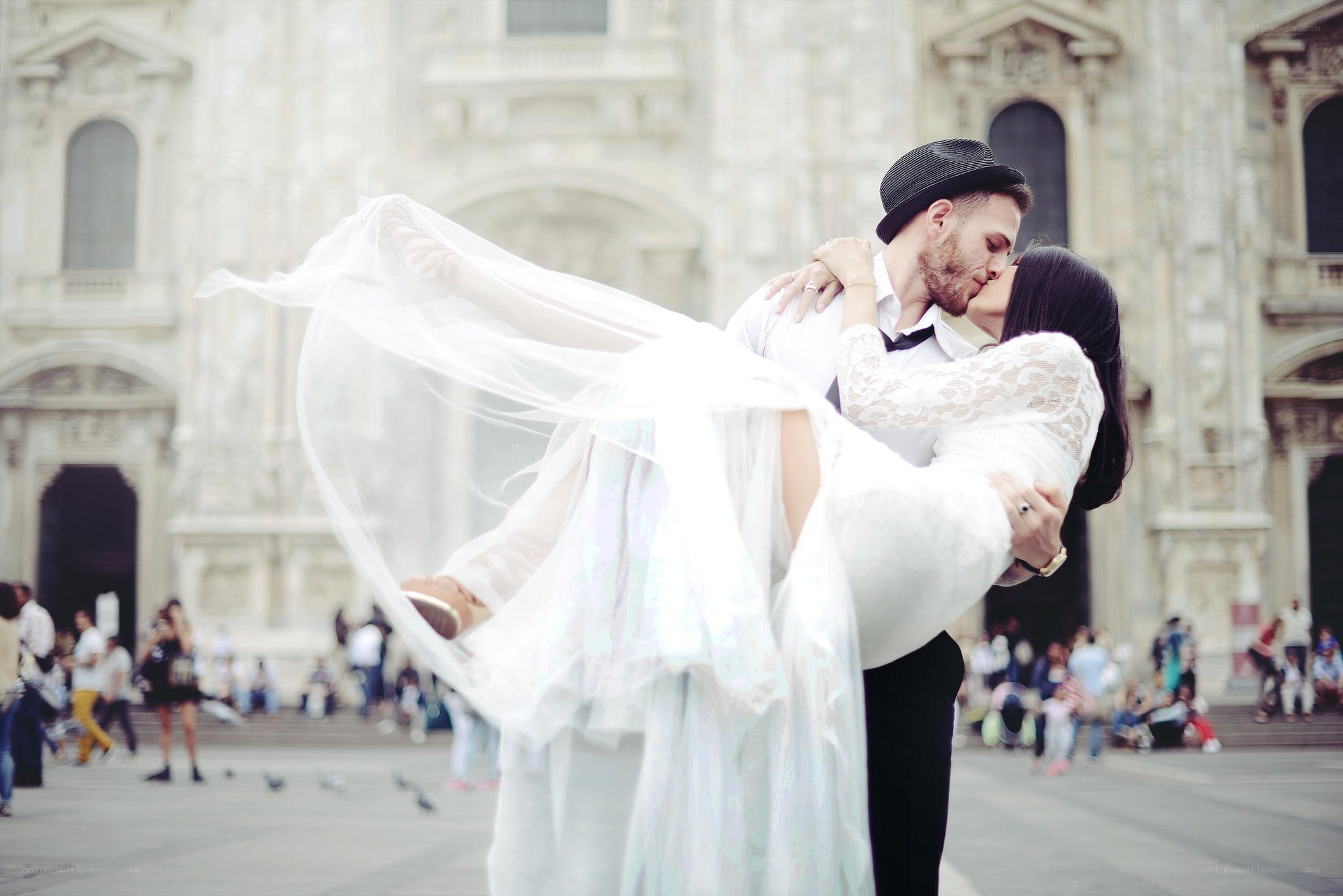 Couple kissing in front of cathedral