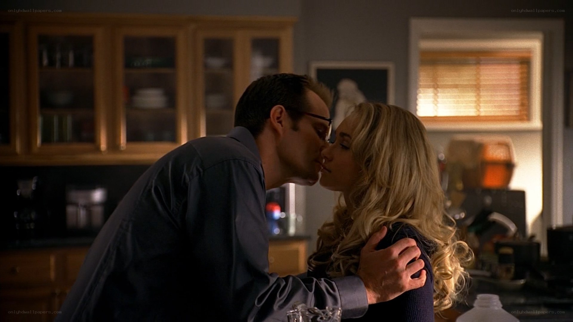 couple kissing in kitchen