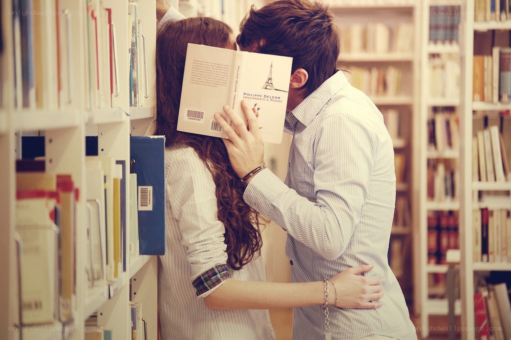 Couple kissing in library
