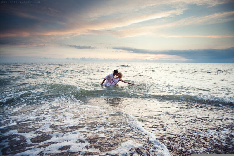 Couple kissing in ocean waves