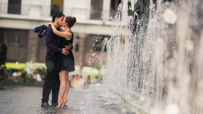 Couple Kissing in Rain — Black, Romantic, Afternoon, Photograph, Fountain, Building