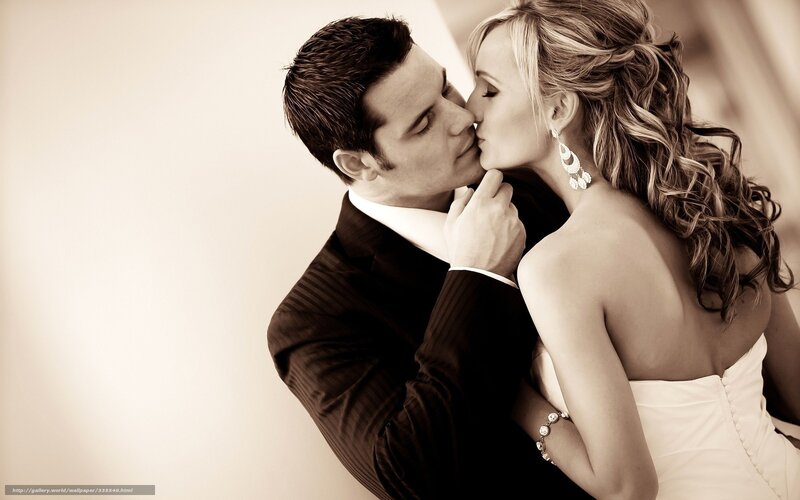 couple kissing in wedding attire