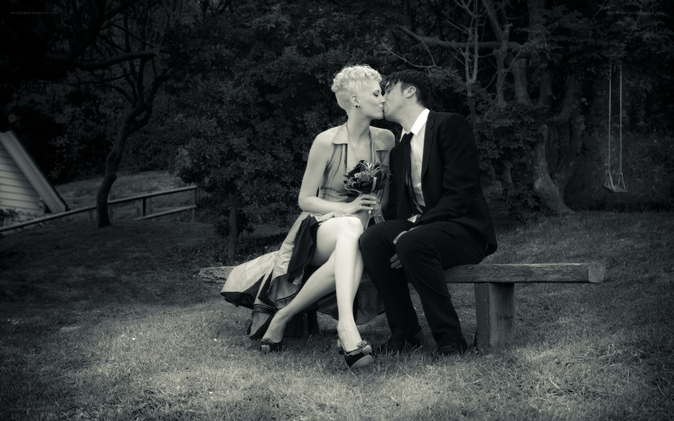 Couple kissing on a bench