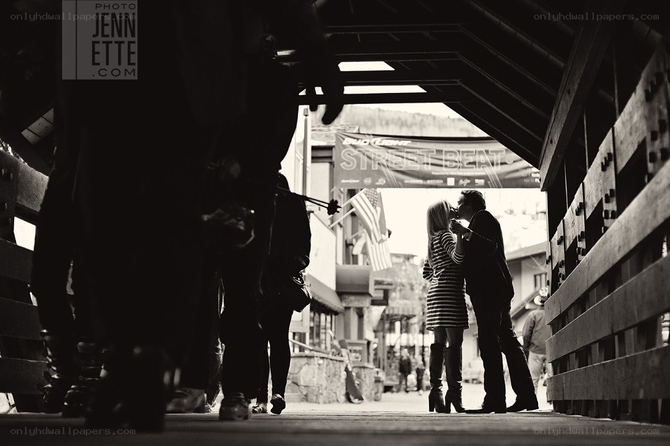 Couple kissing on a bridge