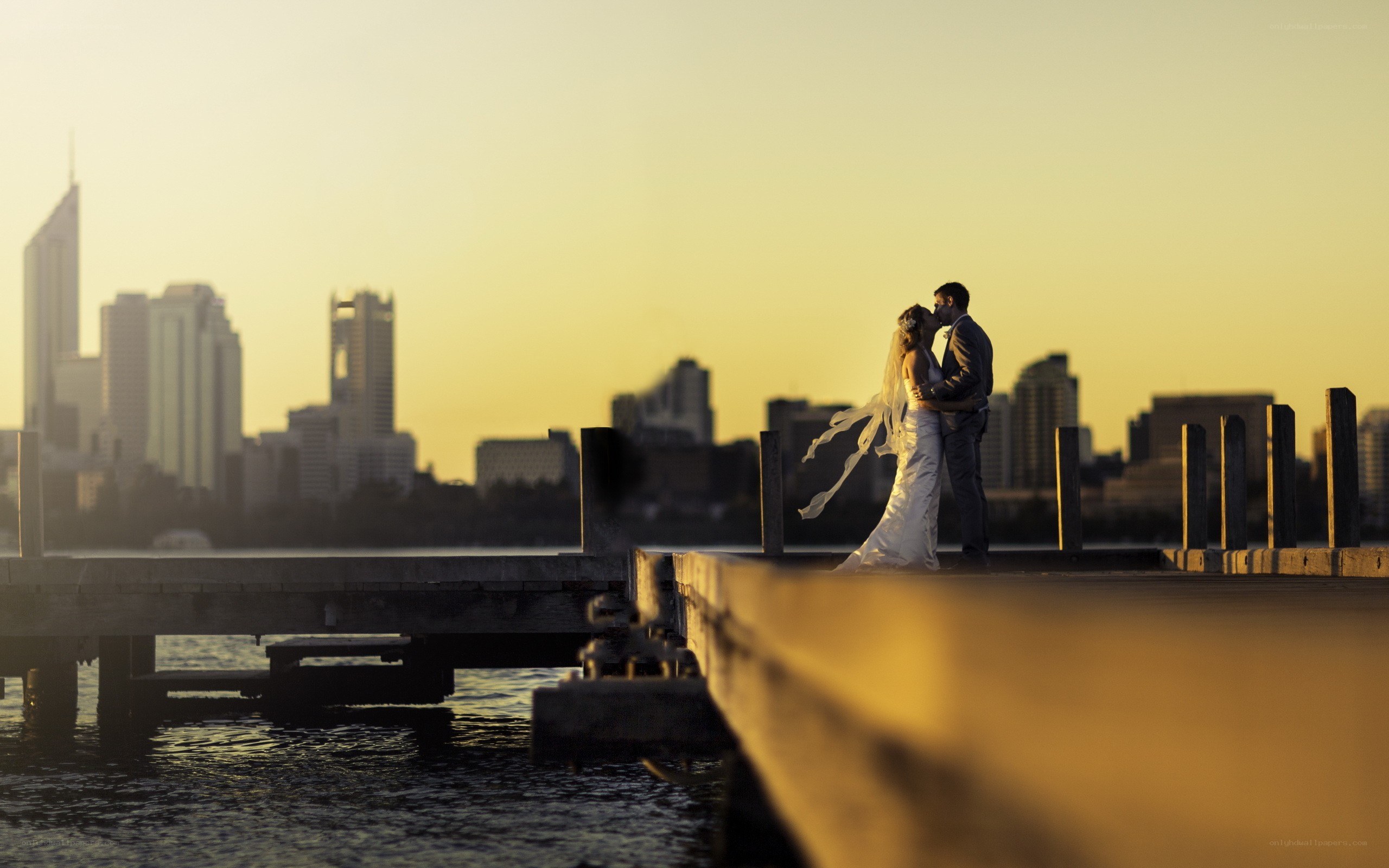 Couple kissing on a dock
