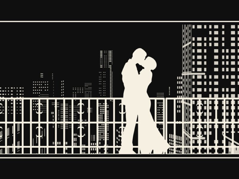 couple kissing on balcony