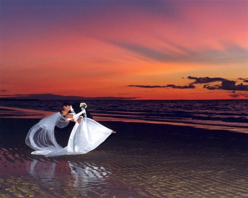 Couple kissing on beach at sunset