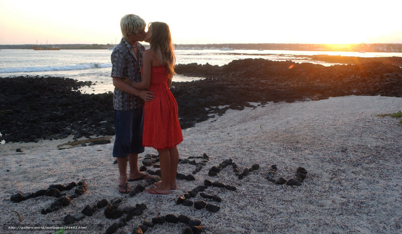 Couple kissing on beach at sunset