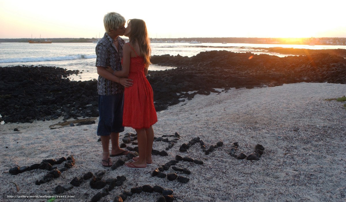 Couple kissing on beach at sunset