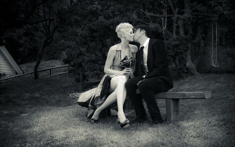 Couple kissing on bench