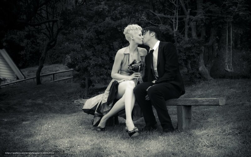Couple kissing on bench