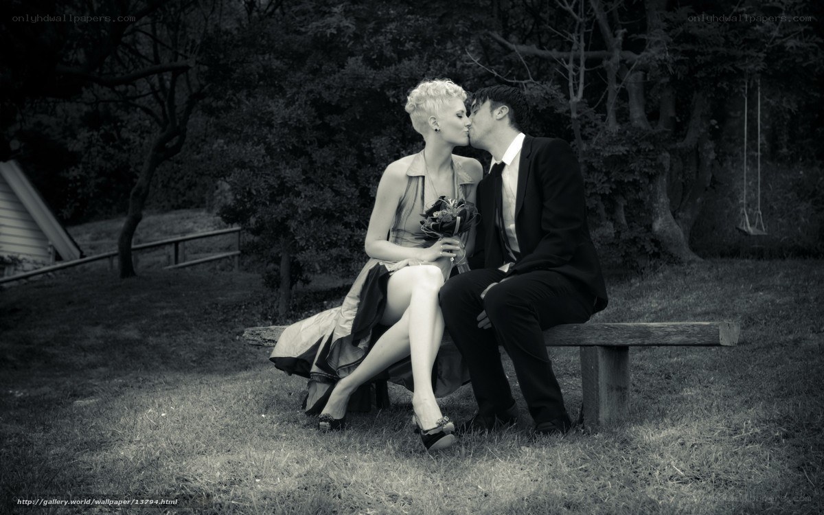 Couple kissing on bench