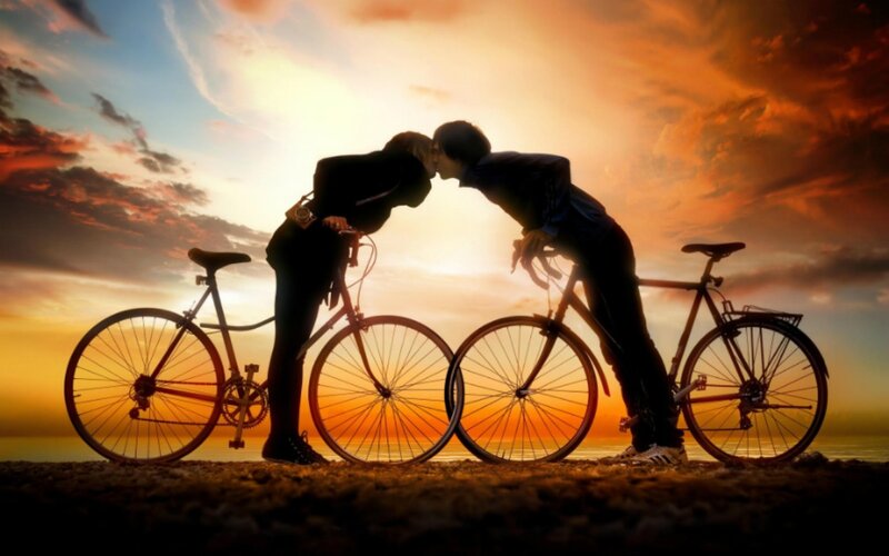 Couple Kissing on Bikes — Orange