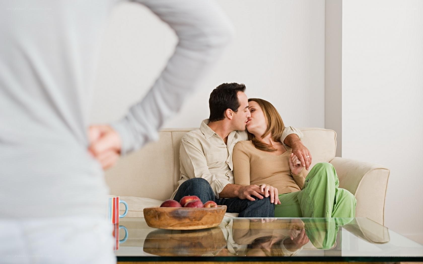 Couple kissing on couch