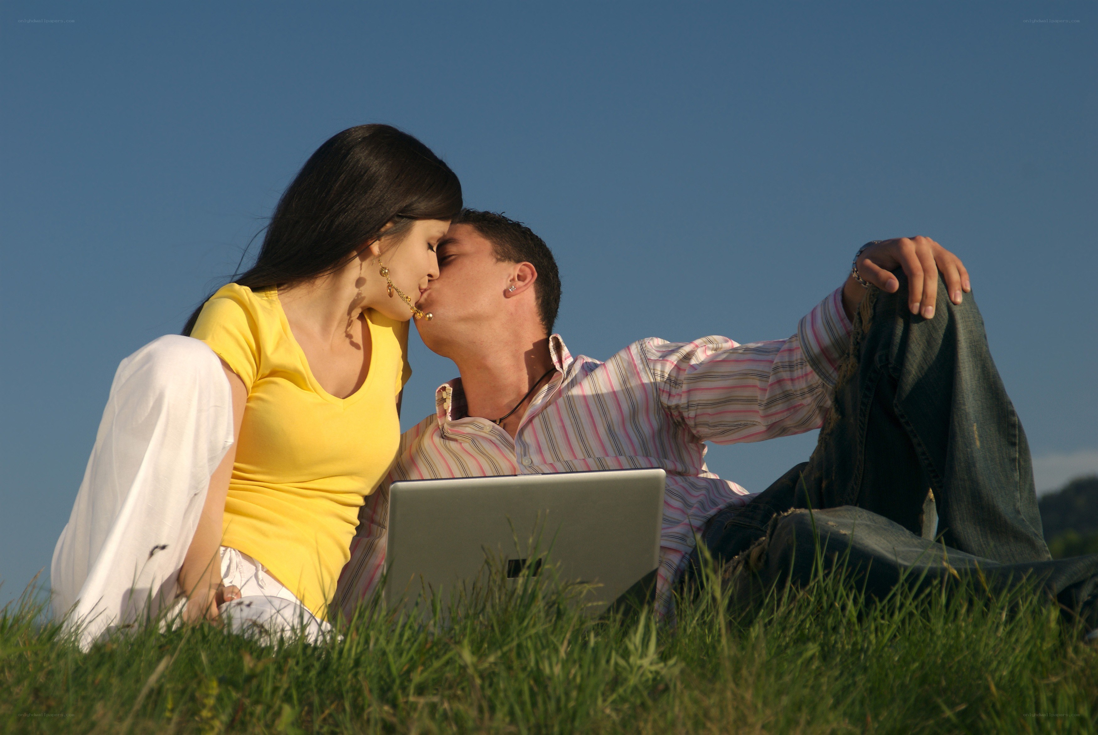 Couple kissing on grass