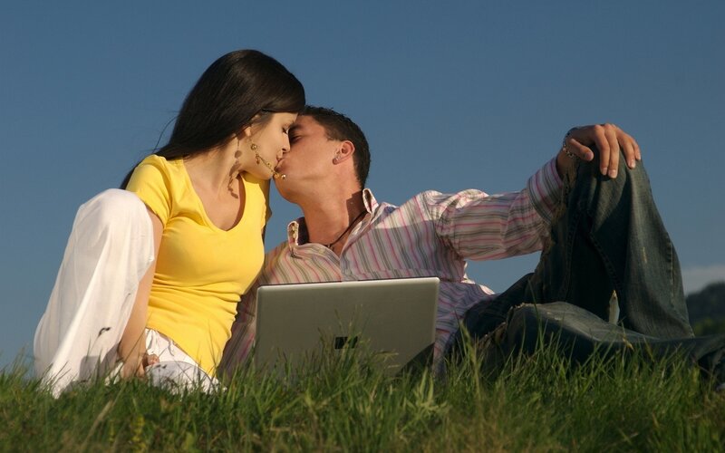 Couple kissing on grass