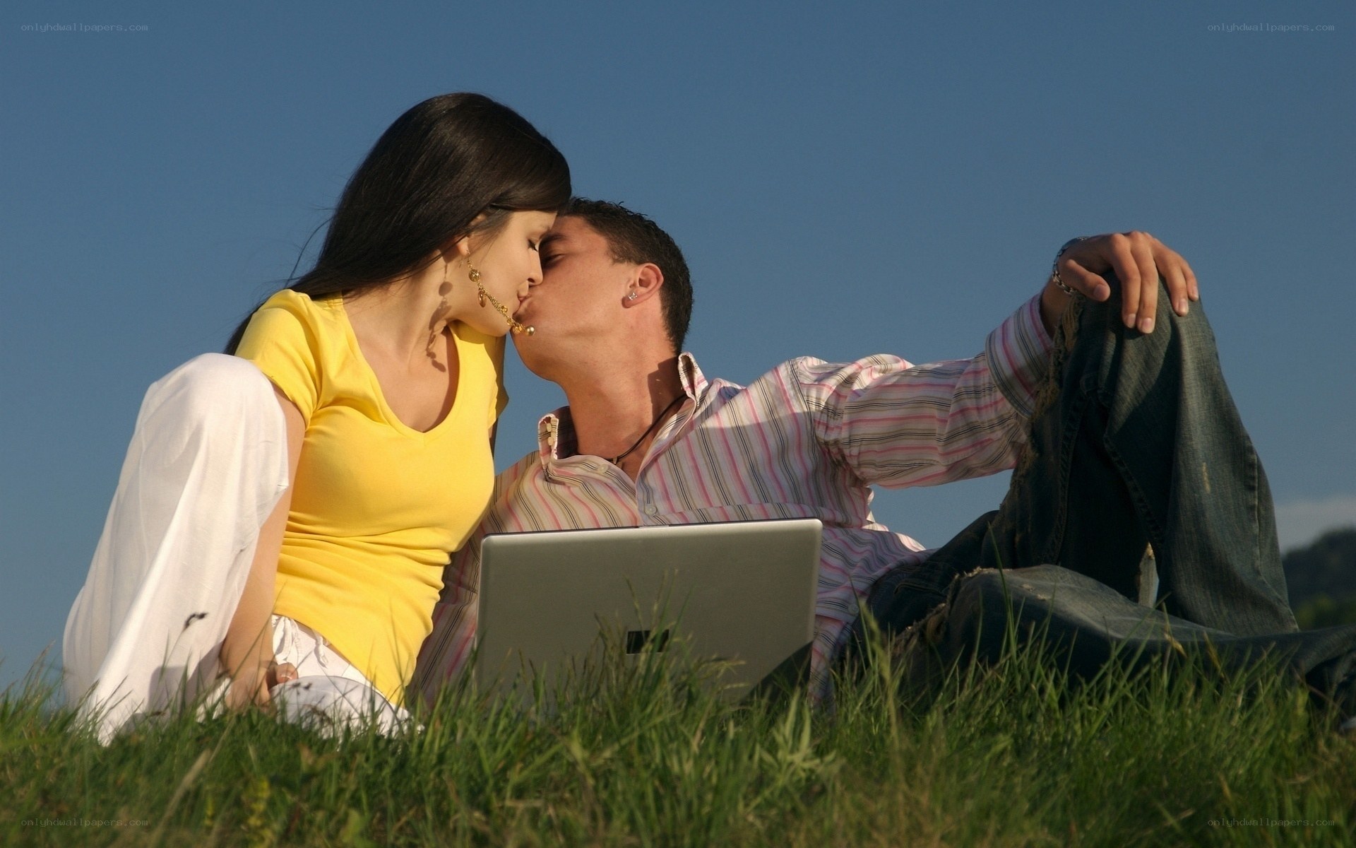 Couple kissing on grass