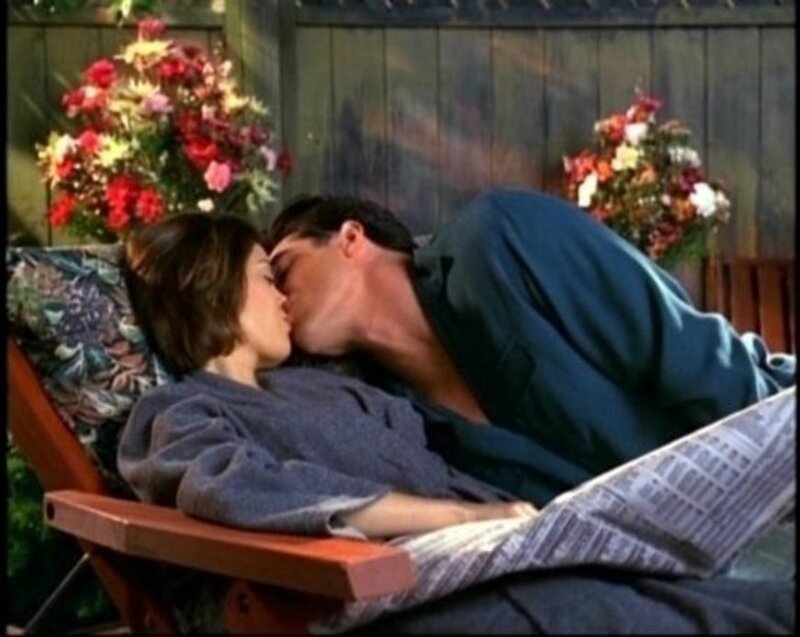 couple kissing on lounge chair