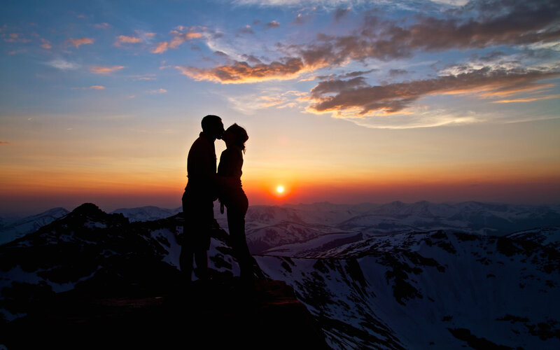 Couple Kissing on Mountain — Orange, Dramatic