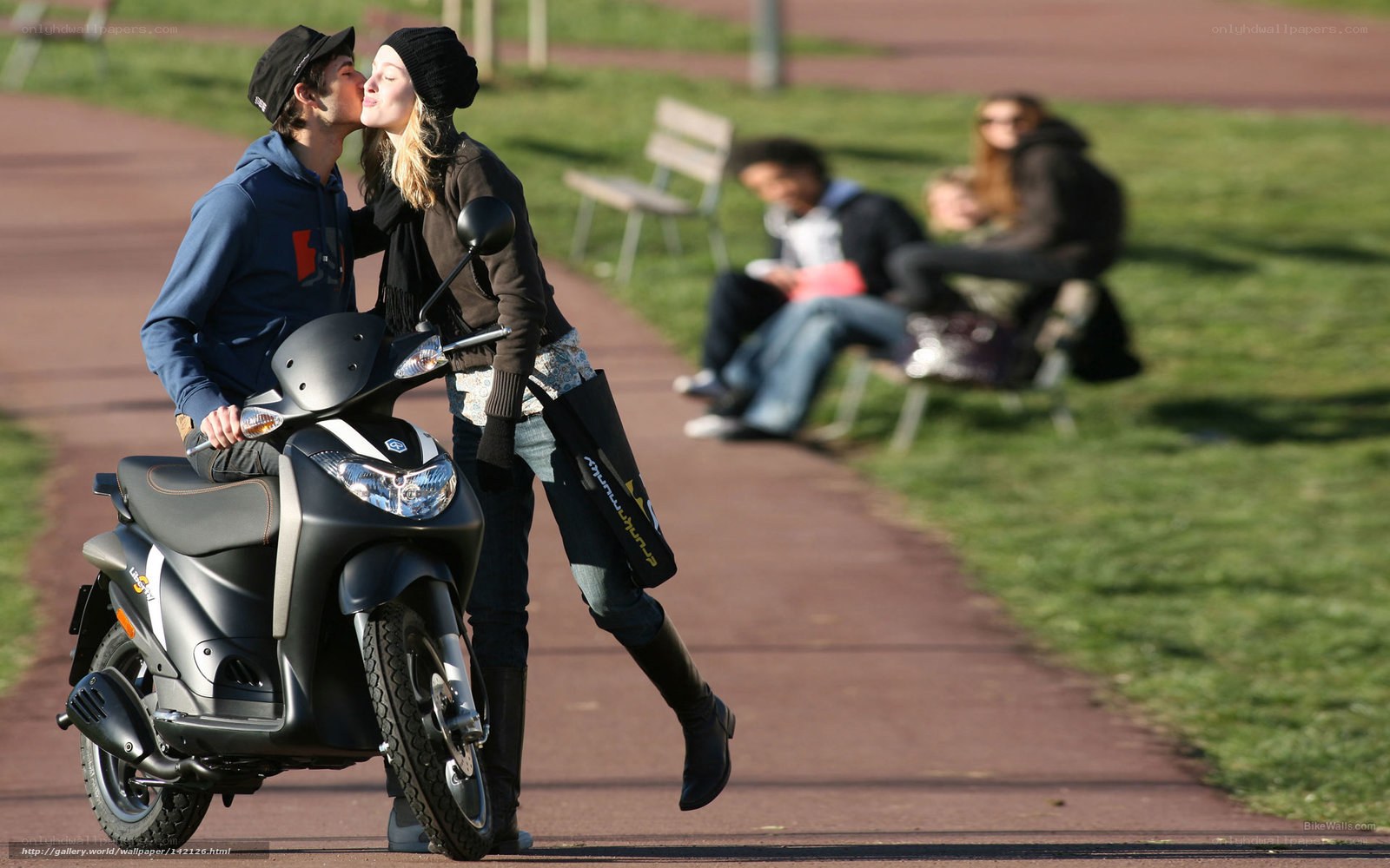 Couple kissing on scooter